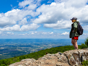 A Shenandoah hiker admiring the view from the summit