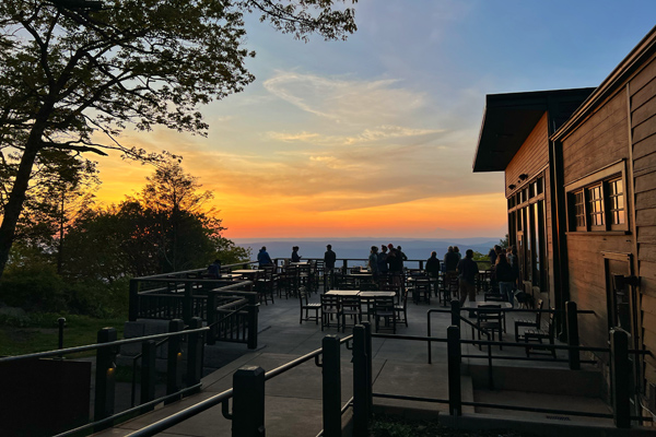 A group of guests enjoying the outdoor porch at Skyland in Shenandoah National Park