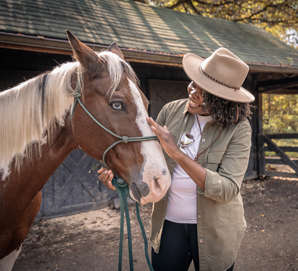 A Skyland guest petting a horse in Shenandoah National Park