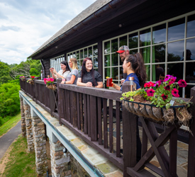 A group of guests on the balcony at Big Meadows Lodge
