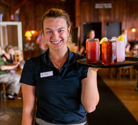 A server at the New Market Taproom carrying a tray of drinks
