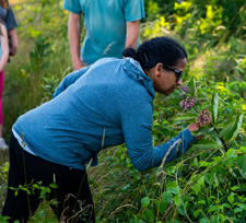 A Shenandoah National Park visitor smelling flowers on a hike